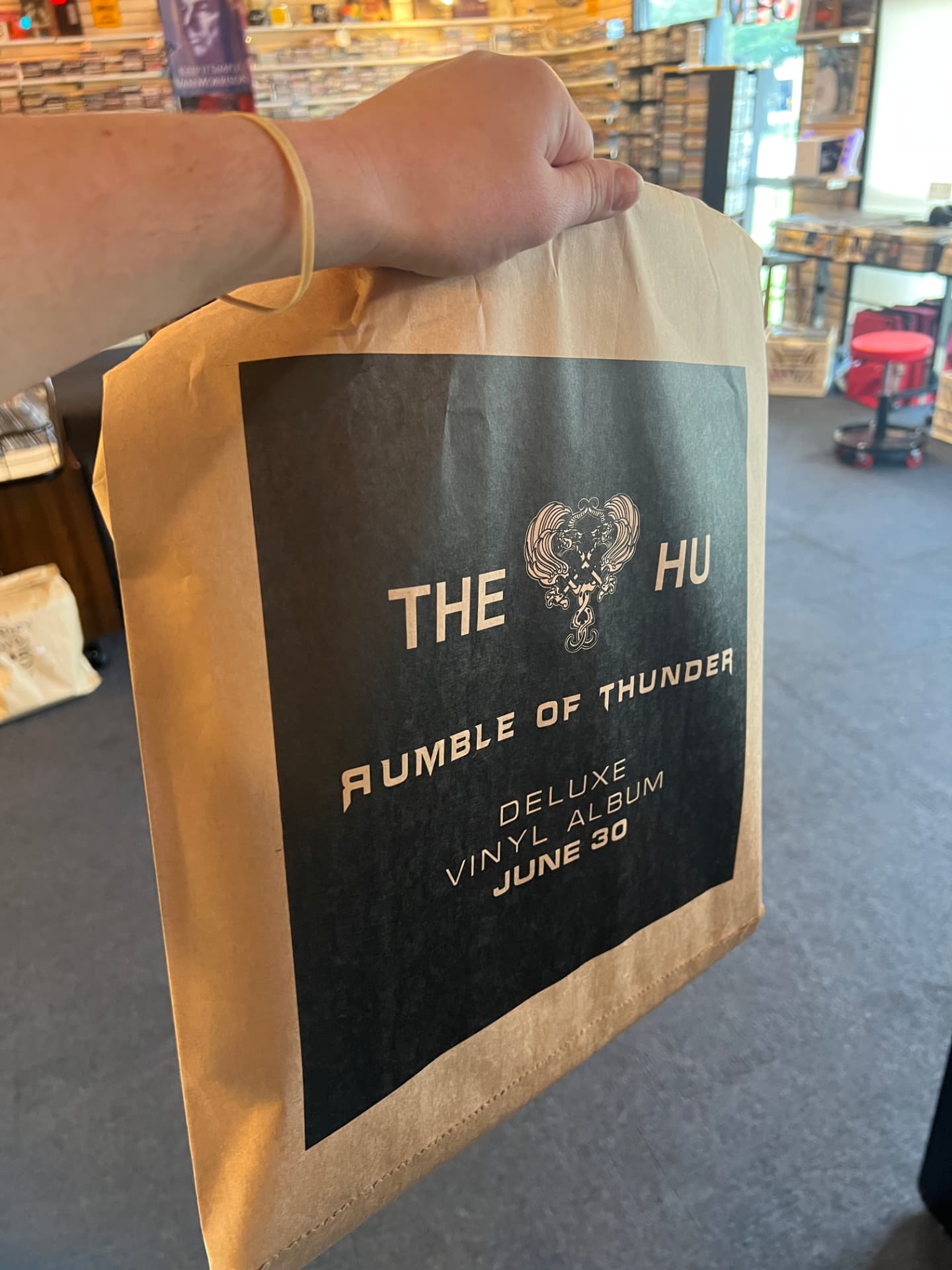 Kraft record store bag printed with The Hu album art