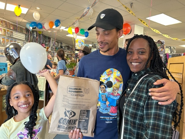 Family holding a printed kraft bag inside a shop
